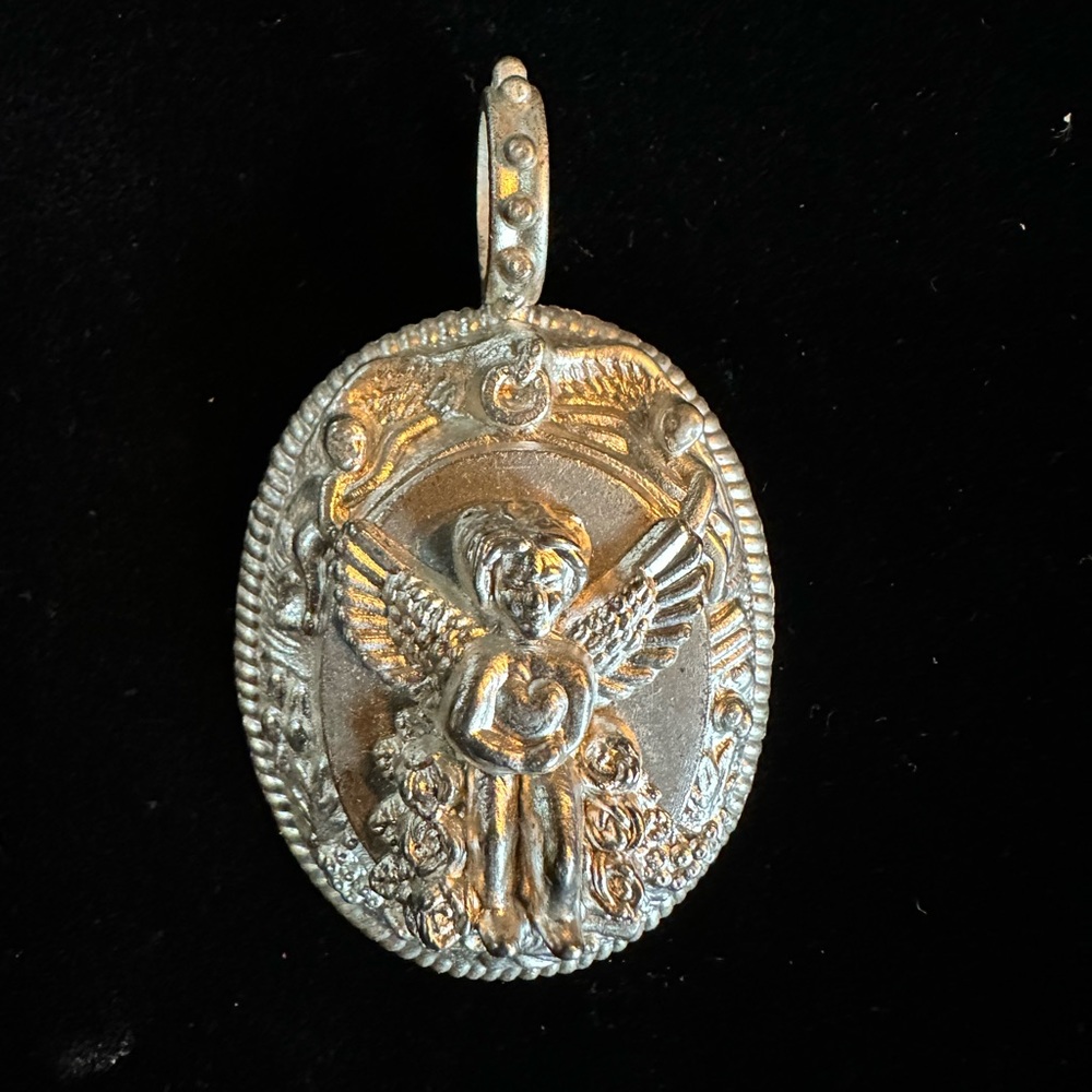 Rebecca Collins silver tone angel pendant.